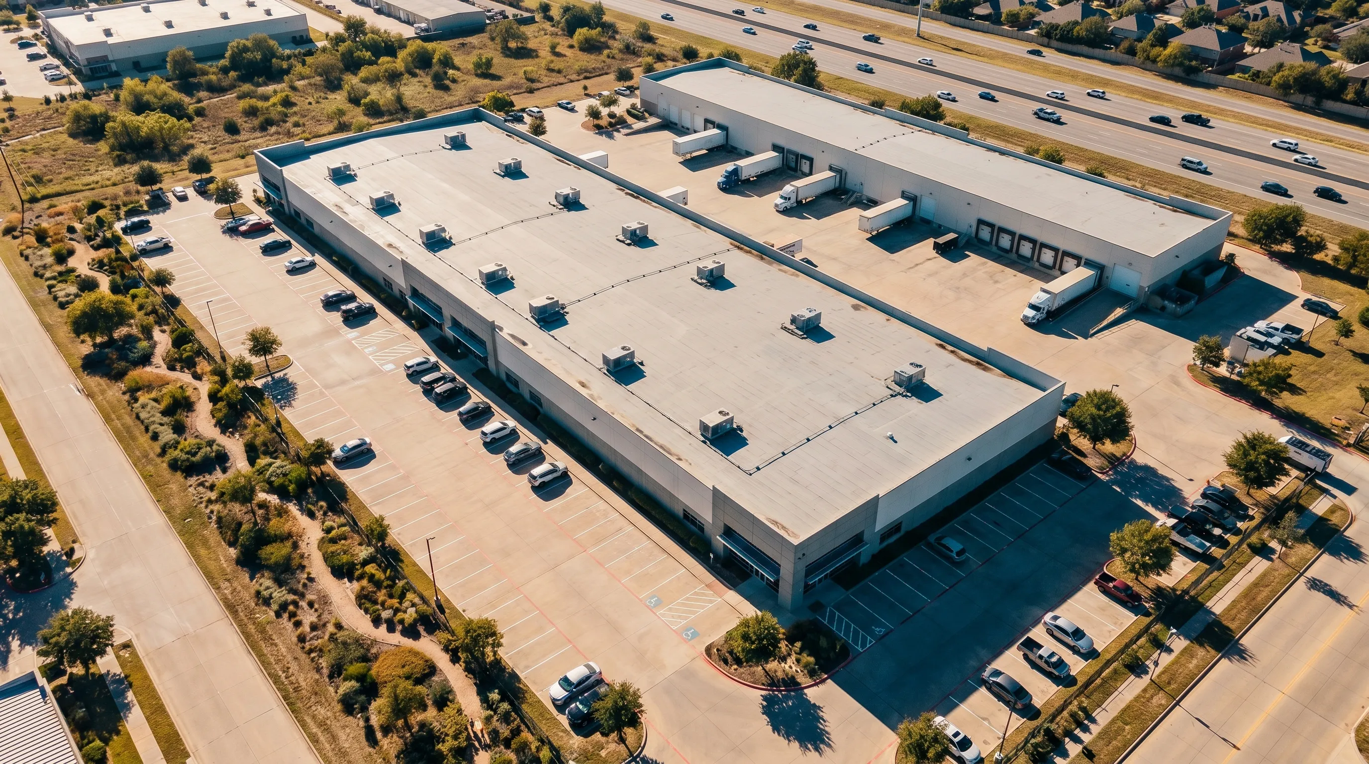Aerial photo of a commercial building showing parking and access.